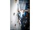 A young boy scales an indoor rock climbing wall with various grips at 4516 W Fortune Dr, Phoenix, AZ 85086