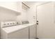 Functional laundry room includes a white washer and dryer and storage at 4516 W Fortune Dr, Phoenix, AZ 85086