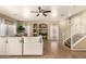 Bright, open-concept living room with large sectional sofa and elegant staircase at 4516 W Fortune Dr, Phoenix, AZ 85086