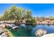 Picturesque pond surrounded by lush landscaping and a colorful playground for Gathering enjoyment at 4516 W Fortune Dr, Phoenix, AZ 85086