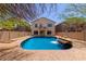 Inviting backyard pool area with privacy fence, tanning area and lush landscaping at 4516 W Fortune Dr, Phoenix, AZ 85086
