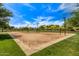 Well-maintained sand volleyball court surrounded by grassy areas, under a beautiful sky for outdoor activities and fun at 4516 W Fortune Dr, Phoenix, AZ 85086