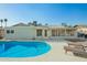 Backyard pool area with artificial turf and covered patio at 4549 W Poinsettia Dr, Glendale, AZ 85304