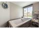Relaxing bathroom featuring a large soaking tub, stylish tile accents, and a serene view, perfect for unwinding at 4549 W Poinsettia Dr, Glendale, AZ 85304