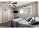 Cozy bedroom featuring a ceiling fan, large windows, and sliding-door closet for ample storage at 4549 W Poinsettia Dr, Glendale, AZ 85304