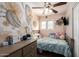 Cozy bedroom featuring pastel pink walls, a floral mural, and a ceiling fan at 4549 W Poinsettia Dr, Glendale, AZ 85304