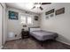 Neutral bedroom featuring a ceiling fan, window, and gamer-themed wall decor at 4549 W Poinsettia Dr, Glendale, AZ 85304