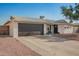 Attractive home featuring a large garage, covered entry and tidy xeriscaped front yard at 4549 W Poinsettia Dr, Glendale, AZ 85304