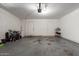 Well lit garage with two interior access doors and concrete flooring at 4549 W Poinsettia Dr, Glendale, AZ 85304