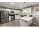Bright kitchen with white cabinets, stainless steel appliances, stylish backsplash, and wood-look flooring at 4549 W Poinsettia Dr, Glendale, AZ 85304