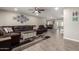 Spacious living room with modern tile floors, neutral walls, and bright recessed lighting at 4549 W Poinsettia Dr, Glendale, AZ 85304