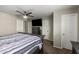 Spacious bedroom featuring a ceiling fan, soft carpet, and ample closet space, offering comfort and convenience at 4549 W Poinsettia Dr, Glendale, AZ 85304