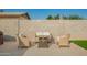 Backyard patio area with outdoor seating and view of perimeter wall at 4549 W Poinsettia Dr, Glendale, AZ 85304