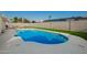 Backyard swimming pool featuring artificial turf and perimeter block fence at 4549 W Poinsettia Dr, Glendale, AZ 85304