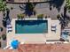 Aerial view of a pool with lounge chairs, outdoor kitchen, hot tub, and mature landscaping at 4822 N Barranco Dr, Litchfield Park, AZ 85340
