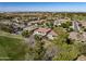 Expansive aerial shot capturing homes nestled in a community with golf course views and mature landscaping at 4822 N Barranco Dr, Litchfield Park, AZ 85340