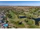 Expansive aerial view of community, golf course, ponds, and desert landscape at 4822 N Barranco Dr, Litchfield Park, AZ 85340