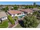 Aerial view of a private pool and lush outdoor living space with an outdoor kitchen in a golf community at 4822 N Barranco Dr, Litchfield Park, AZ 85340