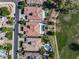 Aerial view showcasing home exteriors and pristine pools nestled next to a well-manicured golf course at 4822 N Barranco Dr, Litchfield Park, AZ 85340