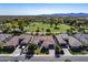 Aerial view of home, manicured front yard and landscaping, backing onto lush golf course at 4822 N Barranco Dr, Litchfield Park, AZ 85340