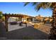 Backyard pergola offers shade next to a built-in hot tub, a swimming pool, and a grill for outdoor entertaining at 4822 N Barranco Dr, Litchfield Park, AZ 85340