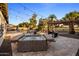 Lush backyard with a hot tub, grill, and pool under string lights, creating an inviting space for outdoor relaxation at 4822 N Barranco Dr, Litchfield Park, AZ 85340