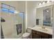 Bright bathroom featuring a glass-enclosed shower and vanity with mirror, providing a clean and functional space at 4822 N Barranco Dr, Litchfield Park, AZ 85340