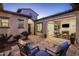 Inviting outdoor courtyard with tiled patio, desert landscaping, and seamless indoor-outdoor flow at 4822 N Barranco Dr, Litchfield Park, AZ 85340