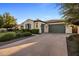 Lovely single-story home with a wide driveway and lush, green landscaping at 4822 N Barranco Dr, Litchfield Park, AZ 85340