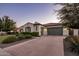 Lovely single-story home with a wide driveway and lush, green landscaping at 4822 N Barranco Dr, Litchfield Park, AZ 85340