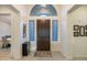 Inviting entryway featuring a wood door, decorative rug, and arched transom window for lots of natural light at 4822 N Barranco Dr, Litchfield Park, AZ 85340