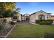 Beautiful home with well-manicured landscaping and gated courtyard entrance at 4822 N Barranco Dr, Litchfield Park, AZ 85340
