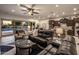 Spacious living room features wood cabinets, a fireplace, comfortable seating, and backyard views at 4822 N Barranco Dr, Litchfield Park, AZ 85340