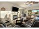 Cozy living room features a fireplace, a bar, comfortable seating, and easy access to the backyard at 4822 N Barranco Dr, Litchfield Park, AZ 85340