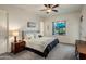 Comfortable main bedroom featuring a large window with a view of the outdoor living area and swimming pool at 4822 N Barranco Dr, Litchfield Park, AZ 85340