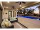Inviting outdoor living space with a comfortable seating area overlooking a sparkling pool and lush landscaping at 4822 N Barranco Dr, Litchfield Park, AZ 85340