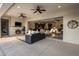 Inviting covered patio featuring a cozy fireplace and a seamless indoor-outdoor living space with direct views into the home at 4822 N Barranco Dr, Litchfield Park, AZ 85340