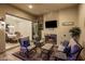 Relaxing covered patio featuring a cozy fireplace, comfortable seating, and seamless indoor-outdoor flow at 4822 N Barranco Dr, Litchfield Park, AZ 85340