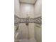 Modern shower with stylish tile, rainfall shower head, and convenient grab bars for added safety at 4822 N Barranco Dr, Litchfield Park, AZ 85340