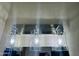 Modern bathroom lighting featuring three lights with glass shades and mirrored backsplash at 6120 N 30Th Ave, Phoenix, AZ 85017