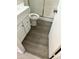 Modern bathroom featuring a toilet, shower and vanity with gray wood-look flooring at 6120 N 30Th Ave, Phoenix, AZ 85017