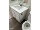 Bathroom vanity featuring stone countertops, nickel faucet and shaker cabinets and drawers at 6120 N 30Th Ave, Phoenix, AZ 85017