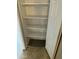 Spacious closet with shelving and a door ajar in the carpeted storage space at 6120 N 30Th Ave, Phoenix, AZ 85017