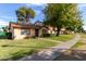 Charming single-story home with a well-maintained lawn and mature shade trees at 6120 N 30Th Ave, Phoenix, AZ 85017