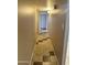 Hallway featuring neutral-toned walls, ceiling lights, and unique accent tile flooring at 6120 N 30Th Ave, Phoenix, AZ 85017