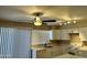Bright kitchen with white cabinets, ceiling fan, and track lighting at 6120 N 30Th Ave, Phoenix, AZ 85017