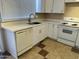 Updated kitchen featuring white cabinets, quartz countertops, and stainless-steel appliances at 6120 N 30Th Ave, Phoenix, AZ 85017