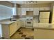 Open kitchen features white cabinets, stone countertops, and breakfast bar at 6120 N 30Th Ave, Phoenix, AZ 85017