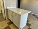 A kitchen island featuring white cabinets and a quartz countertop at 6120 N 30Th Ave, Phoenix, AZ 85017