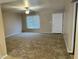 Inviting living room featuring neutral walls, a ceiling fan, a window, and plush brown carpeting at 6120 N 30Th Ave, Phoenix, AZ 85017